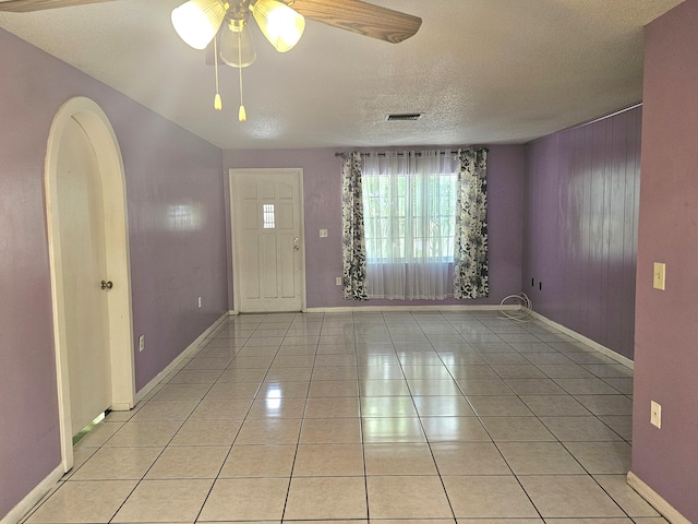 275 SE 16th Ave, Okeechobee, FL 34974 - entryway with baseboards, ceiling fan, light tile patterned floors, and a textured ceiling