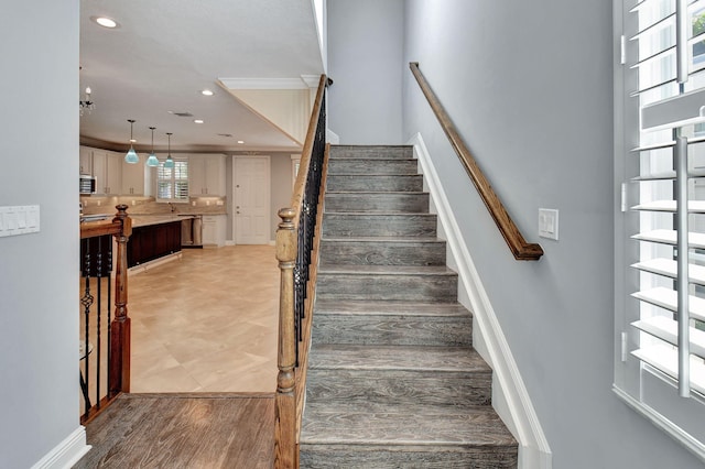 stairs featuring hardwood / wood-style floors