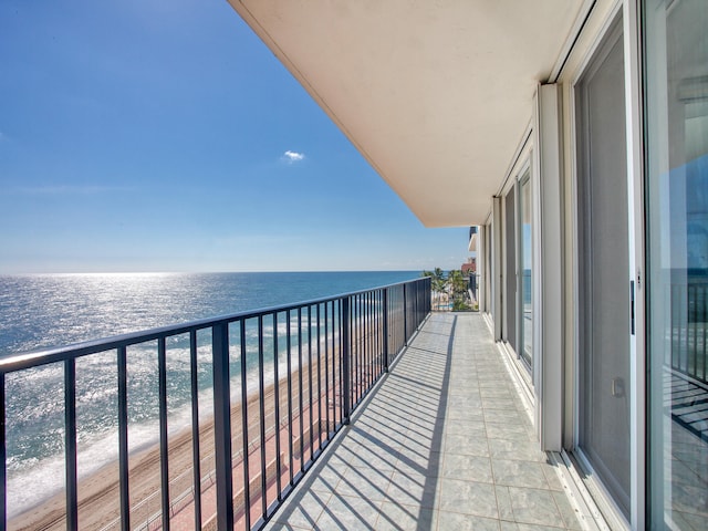 balcony with a water view and a beach view