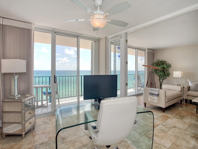 home office with expansive windows and ceiling fan