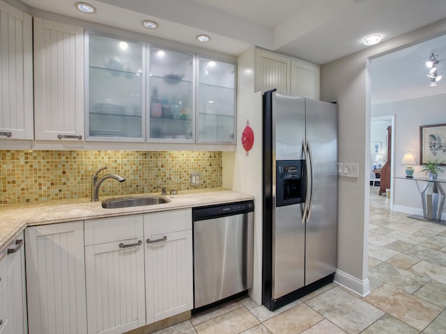 kitchen with backsplash, white cabinetry, sink, and appliances with stainless steel finishes