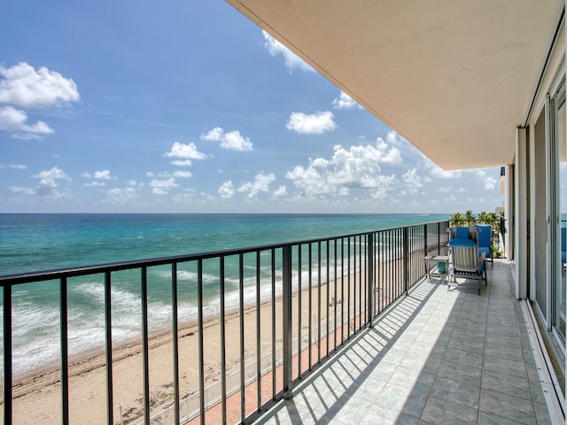 balcony featuring a water view and a view of the beach