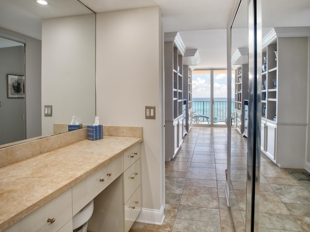 bathroom featuring a water view and a wall of windows