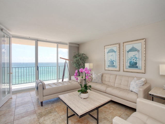 living room with floor to ceiling windows and a water view