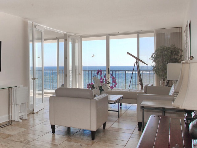 living room with a water view and a wall of windows