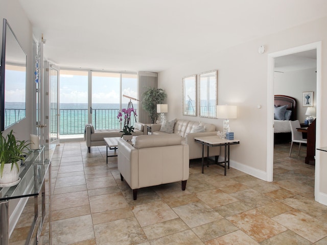 living room with a water view and a wall of windows