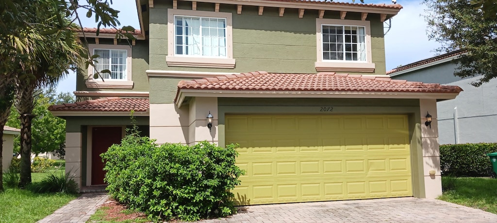 mediterranean / spanish home featuring a garage