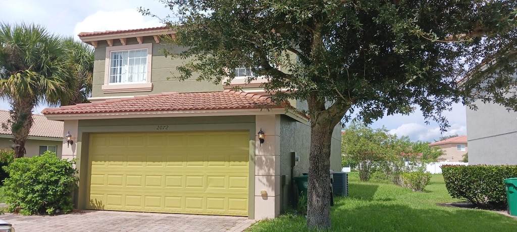 exterior space featuring a front yard and a garage