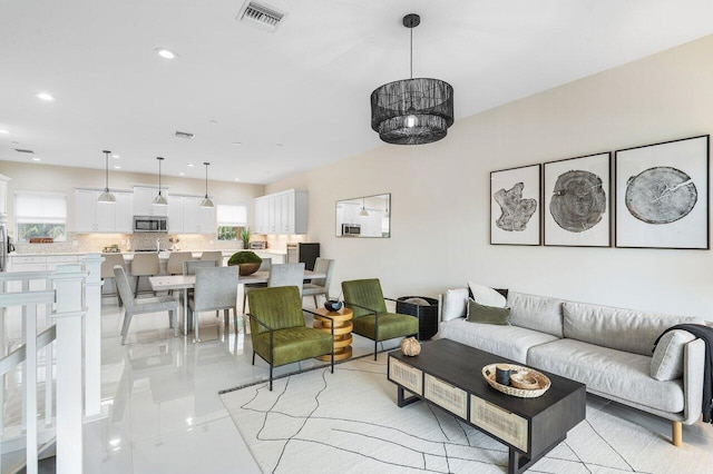 living room featuring a wealth of natural light and light tile patterned flooring