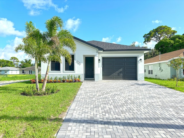 view of front facade featuring a garage and a front lawn