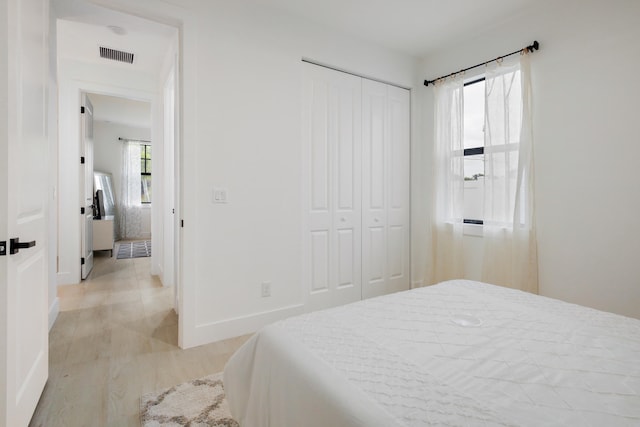 bedroom with a closet and light wood-type flooring