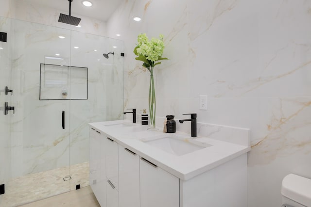 bathroom featuring vanity, an enclosed shower, toilet, and tile walls