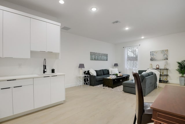 office area featuring light hardwood / wood-style flooring and sink