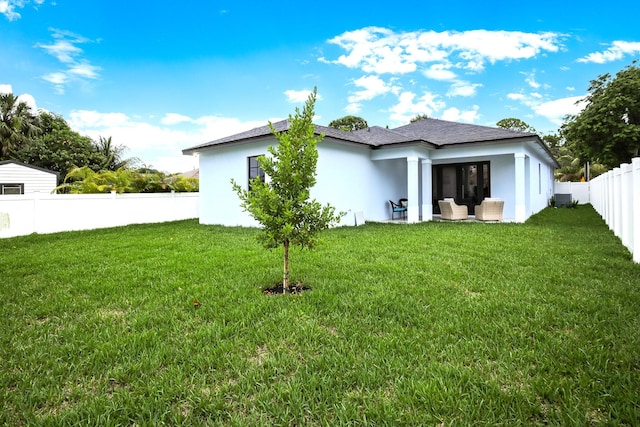 back of house with a yard