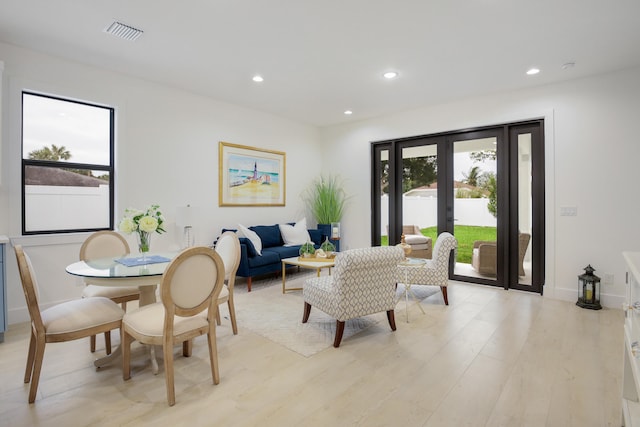 living room with french doors and light hardwood / wood-style flooring