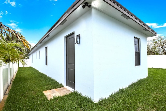 view of side of home featuring a lawn