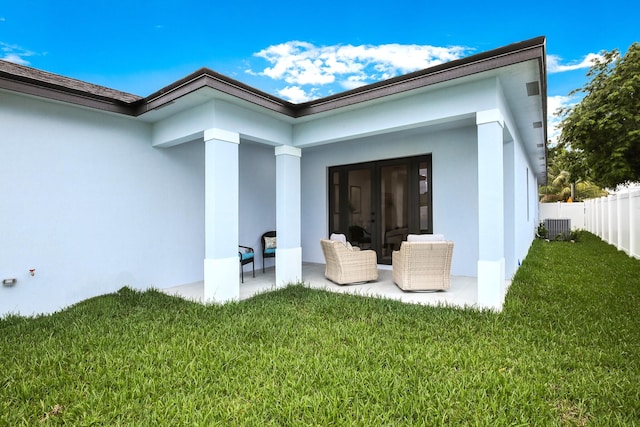 back of house featuring a patio area, french doors, a lawn, and central AC unit