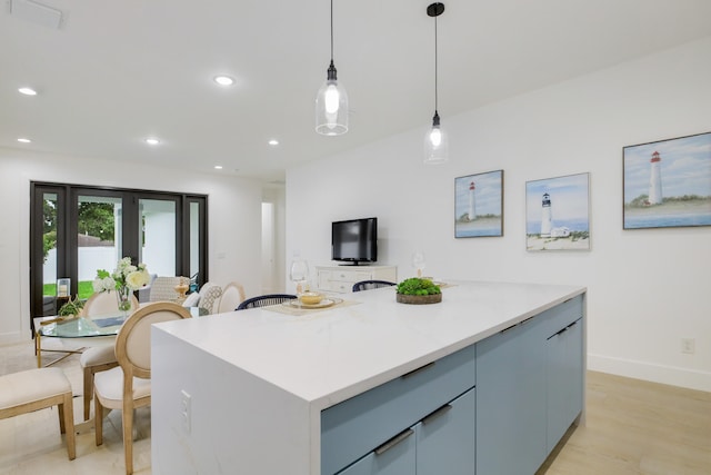 kitchen with a kitchen island, light hardwood / wood-style flooring, and decorative light fixtures