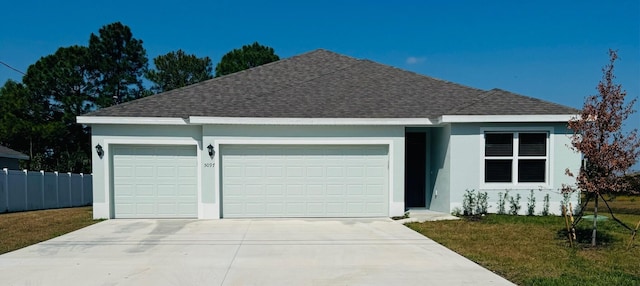 ranch-style house featuring a garage, roof with shingles, driveway, and stucco siding