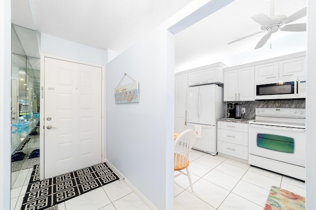 kitchen featuring white appliances, backsplash, ceiling fan, white cabinets, and light tile patterned floors