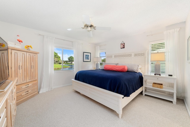 bedroom featuring light carpet and ceiling fan