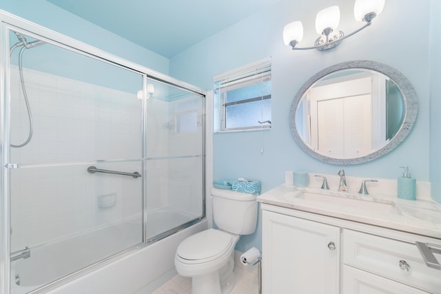 full bathroom featuring toilet, vanity, and shower / bath combination with glass door