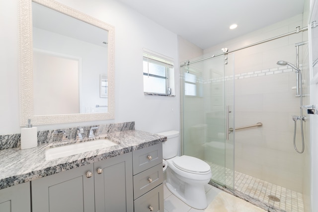 bathroom featuring vanity, tile patterned flooring, toilet, and an enclosed shower