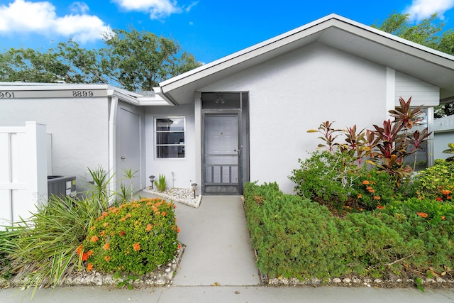 doorway to property featuring central AC