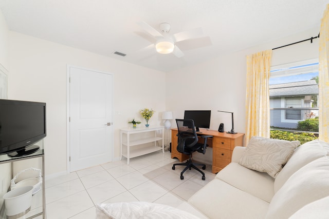 home office featuring light tile patterned flooring and ceiling fan