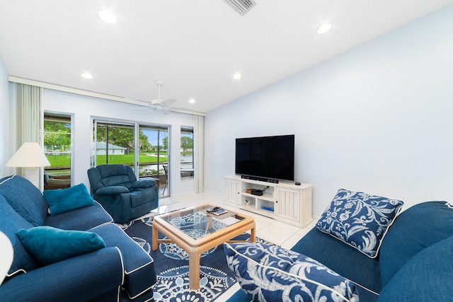 tiled living room featuring ceiling fan and lofted ceiling