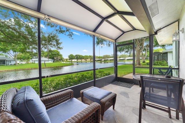 sunroom with a water view and lofted ceiling