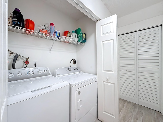 laundry area featuring light hardwood / wood-style floors and independent washer and dryer