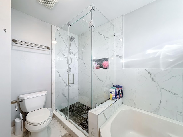 bathroom featuring toilet and independent shower and bath