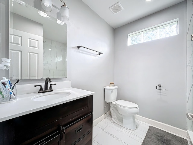 bathroom featuring walk in shower, vanity, and toilet