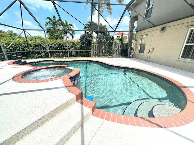 view of swimming pool with a lanai and a patio area