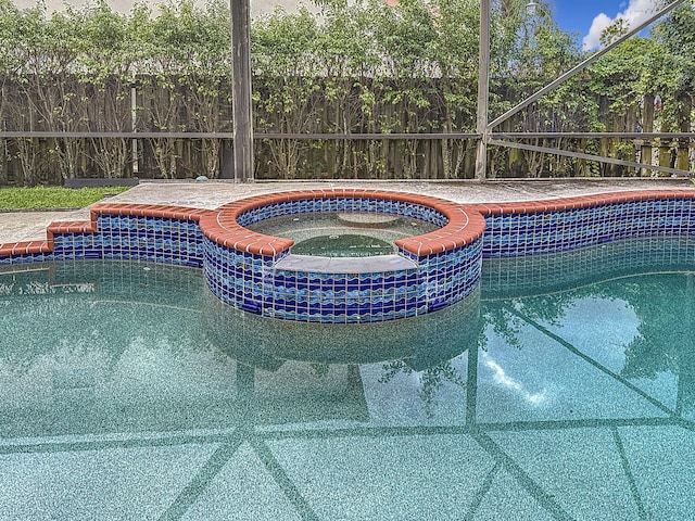 view of pool with an in ground hot tub