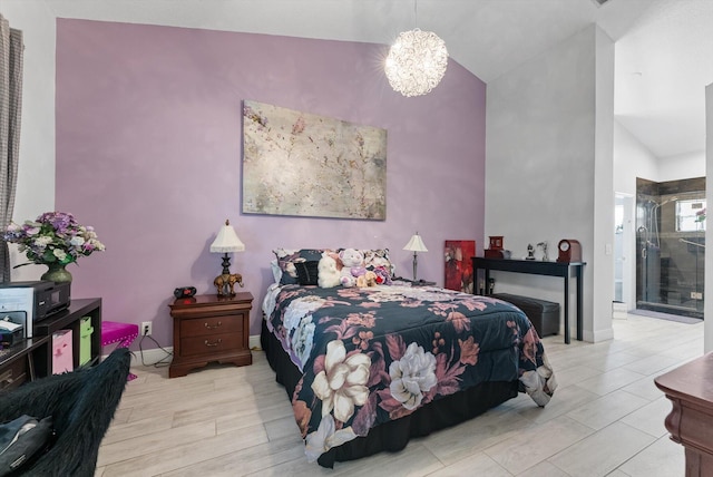 bedroom with light hardwood / wood-style floors, a notable chandelier, and vaulted ceiling