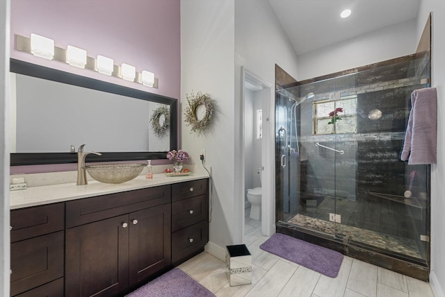 bathroom with vanity, toilet, and walk in shower