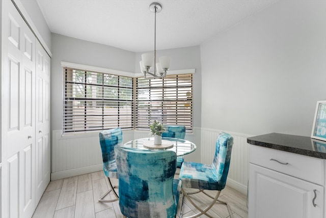 dining room with a chandelier and a textured ceiling