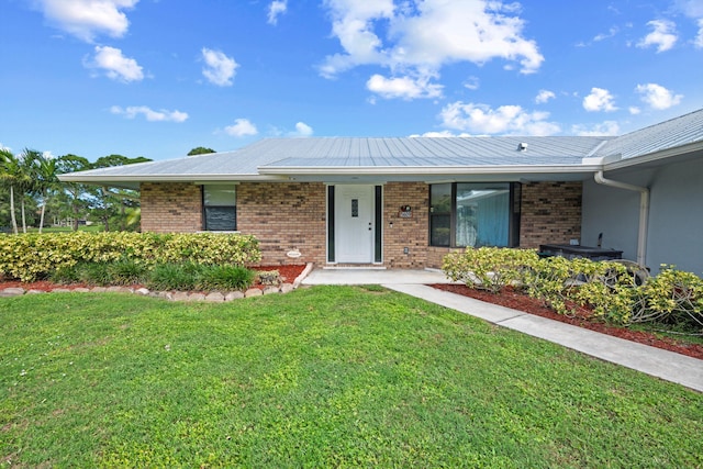 ranch-style house with a front yard and a garage