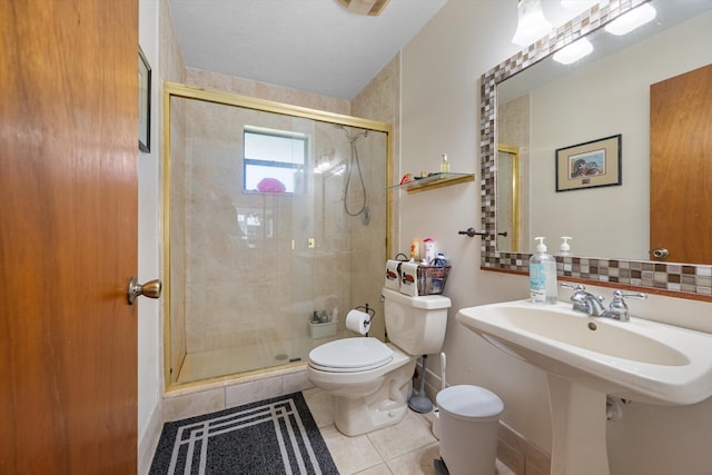 5609 SE Lamay Dr, Stuart, FL 34997 - full bath with toilet, tile patterned flooring, a shower stall, baseboards, and decorative backsplash