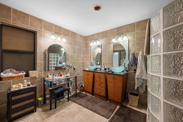 5609 SE Lamay Dr, Stuart, FL 34997 - bathroom featuring tile walls, double vanity, and tile patterned flooring