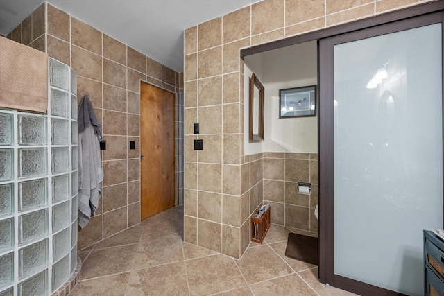 bathroom with vanity, tile walls, and tile patterned flooring