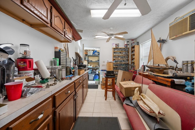 5609 SE Lamay Dr, Stuart, FL 34997 - kitchen featuring ceiling fan, light countertops, a textured ceiling, light tile patterned flooring, and brown cabinetry