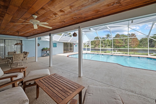 view of swimming pool with a patio, ceiling fan, and a lanai