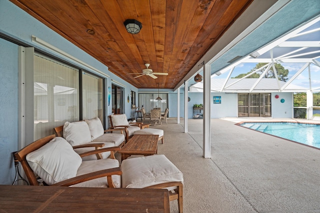 view of swimming pool with a patio, an outdoor living space, a lanai, and ceiling fan