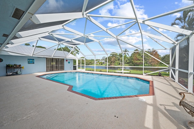 view of pool with a patio and glass enclosure