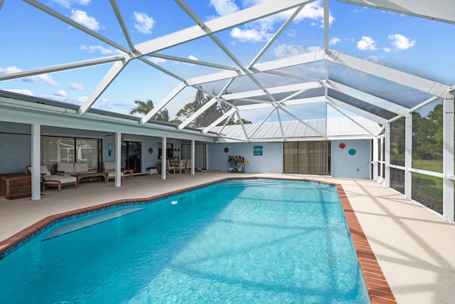 view of swimming pool featuring a patio, a lanai, and an outdoor hangout area