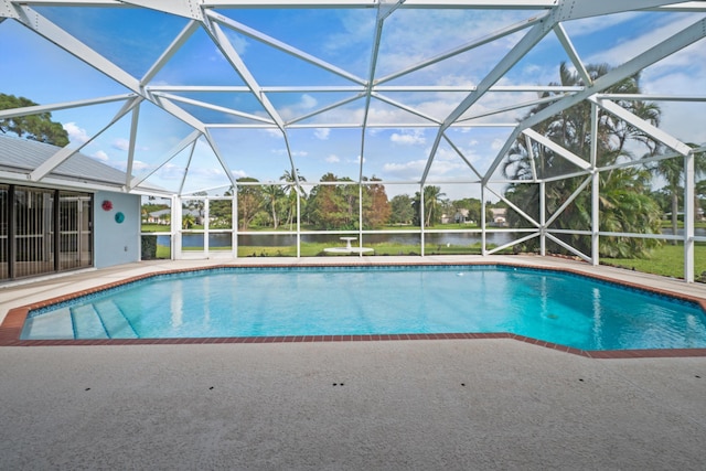 view of swimming pool featuring a patio area and glass enclosure