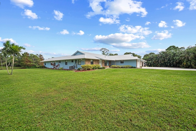 ranch-style home with a front yard and a garage